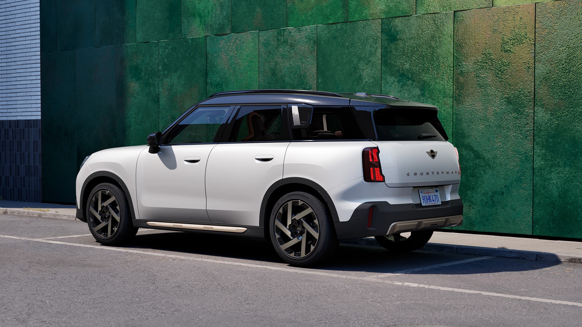 Rear view of a parking MINI Countryman in Smokey Green with Vibrant Silver Roof